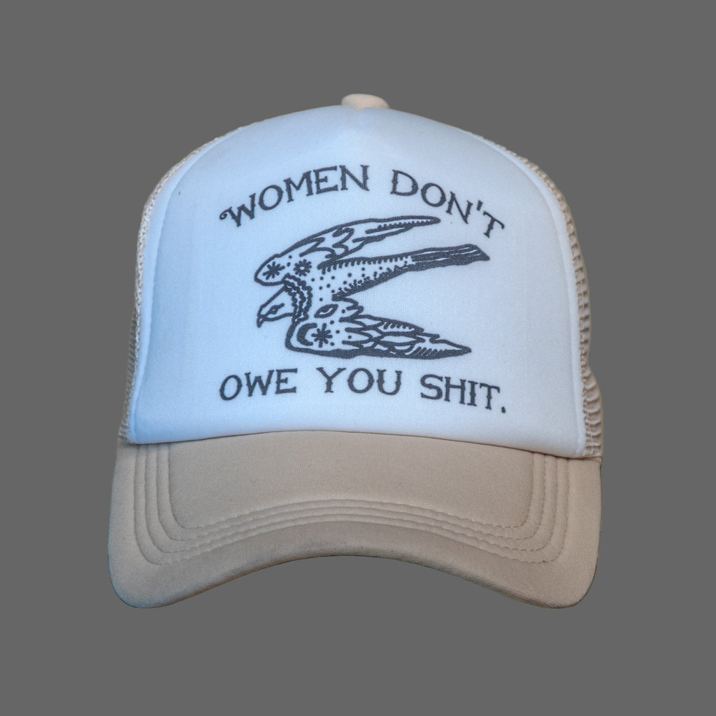 Cap with text and eagle design on a wooden surface