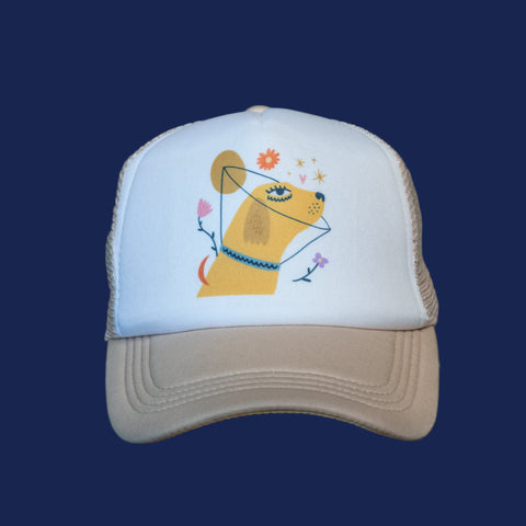 Trucker hat with a dog design on a wooden surface